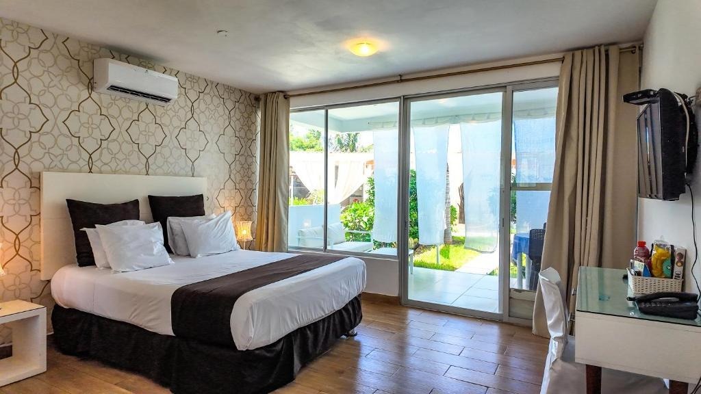 Dormitorio Junior Suite con cama Queen Size y acceso a terraza