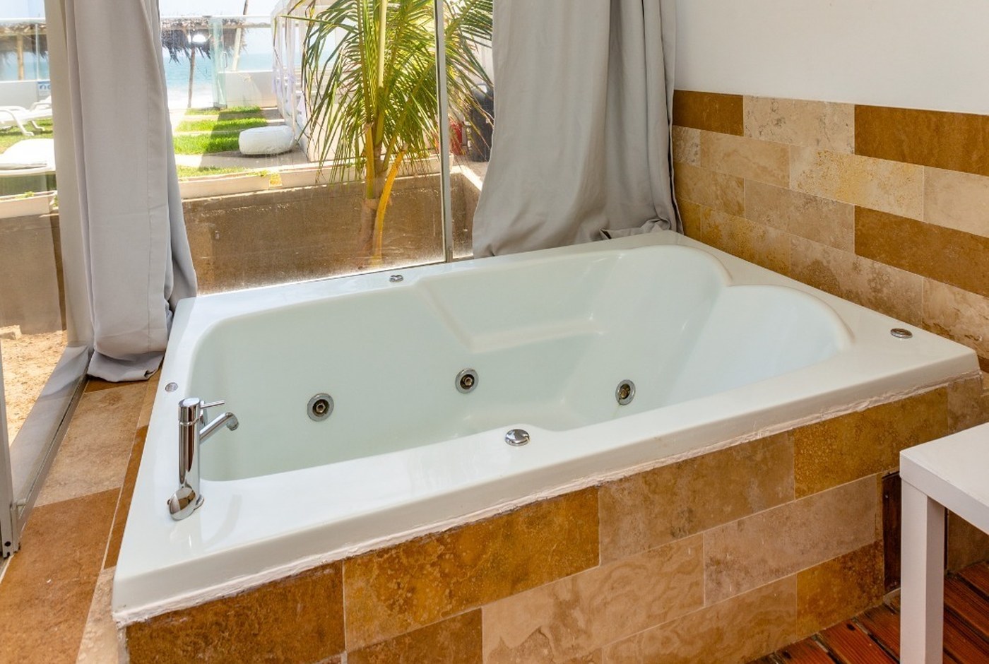 bañera de hidromasaje privada Master Suite con vistas al jardín y mar
